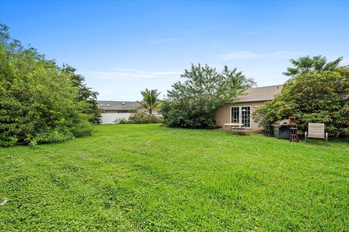 19309 Carolina Circle Boca Raton, FL 33434 - Photo 4 of 30 a front view of a house with garden