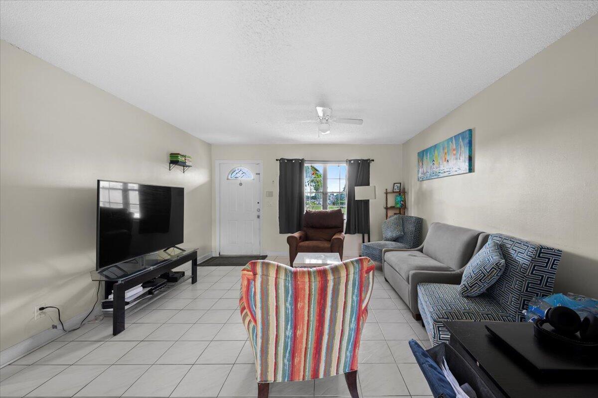 19309 Carolina Circle Boca Raton, FL 33434 - Photo 8 of 30 a living room with furniture and a flat screen tv