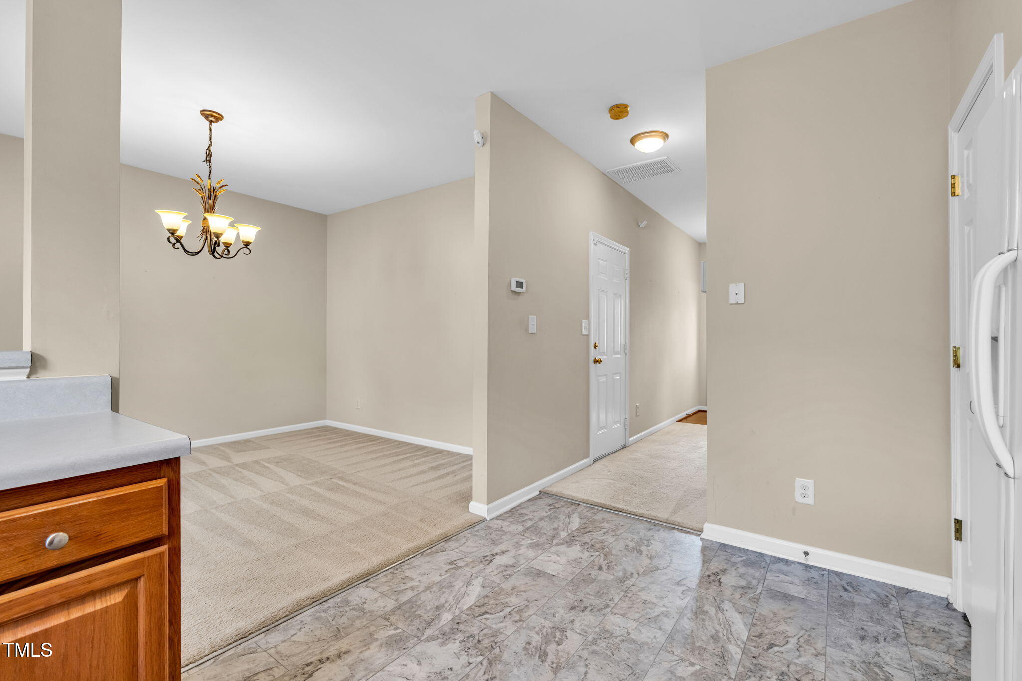 2737 Andover Glen Road Raleigh, NC 27604 - Photo 12 of 36 an empty room with kitchen view and wooden floor