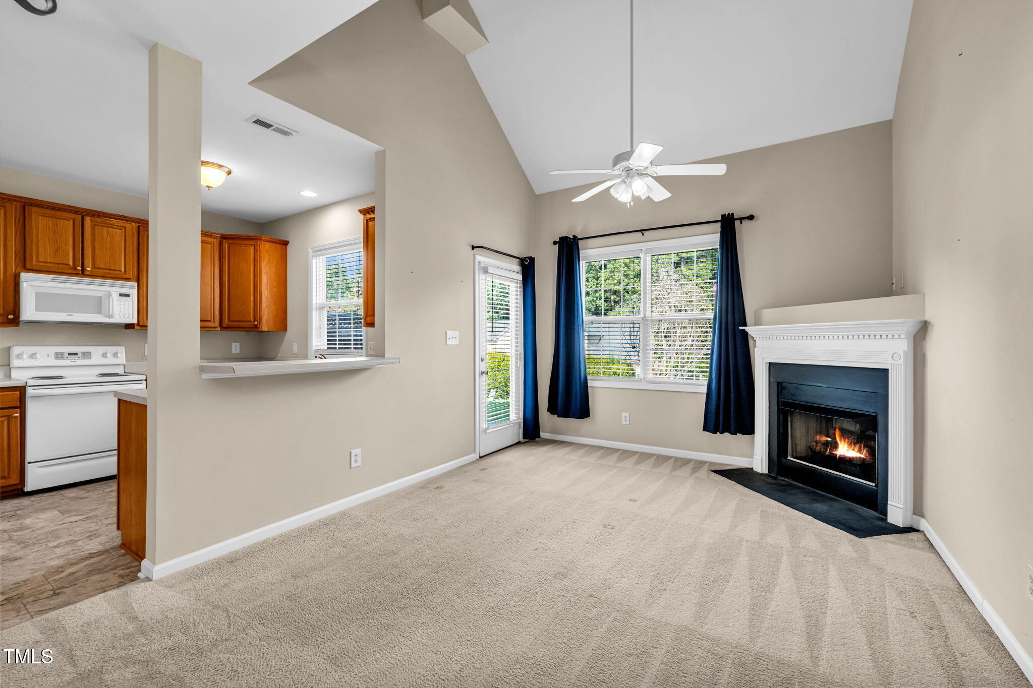 2737 Andover Glen Road Raleigh, NC 27604 - Photo 13 of 36 a view of an empty room with a fireplace and a window