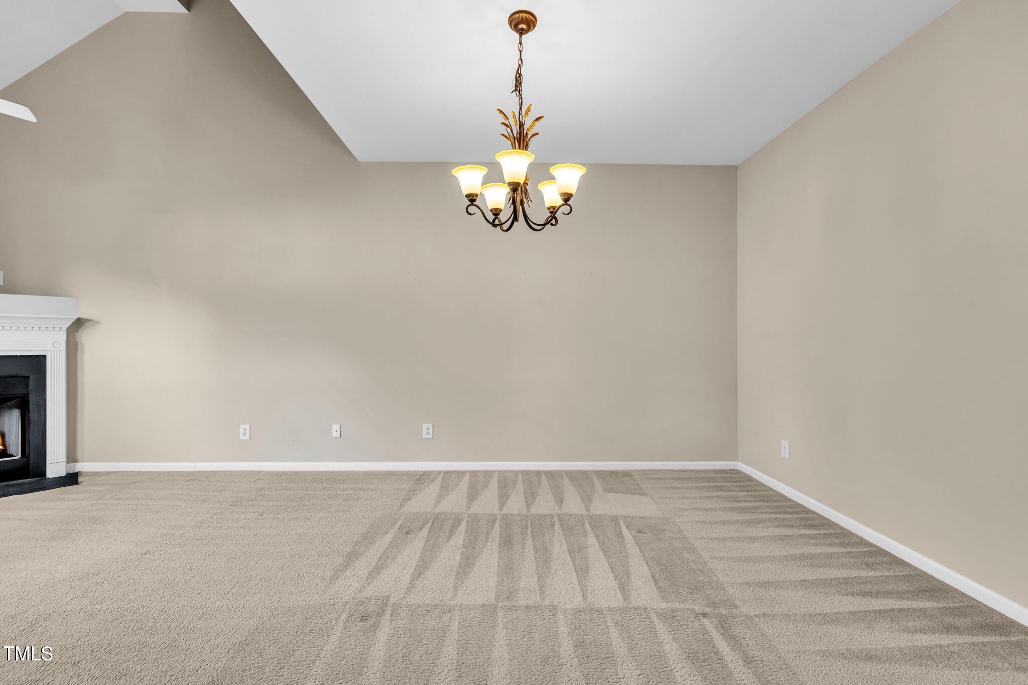 2737 Andover Glen Road Raleigh, NC 27604 - Photo 15 of 36 a view of an empty room with chandelier fan and wooden floor