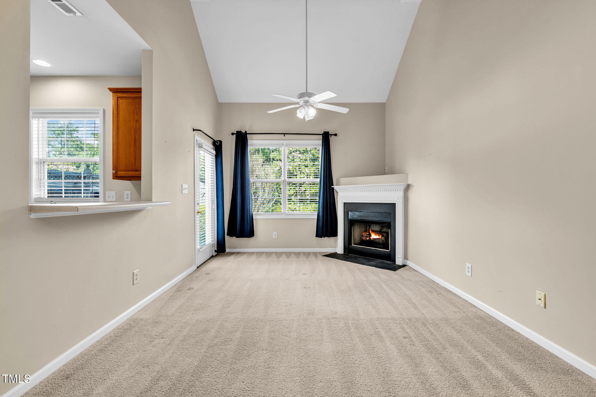 2737 Andover Glen Road Raleigh, NC 27604 - Photo 16 of 36 an empty room with windows and fireplace