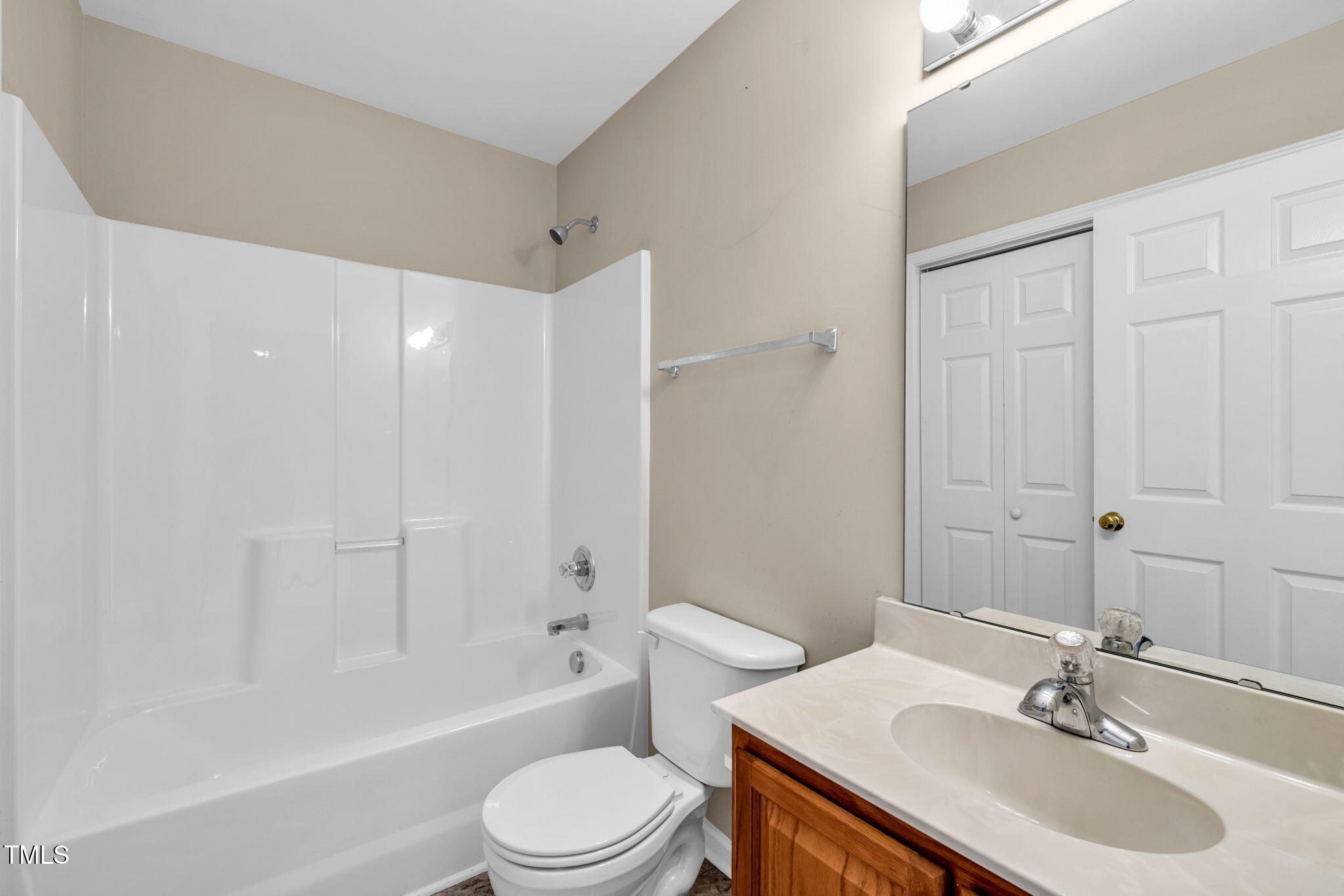 2737 Andover Glen Road Raleigh, NC 27604 - Photo 30 of 36 a bathroom with a toilet a sink a mirror a bathtub and vanity