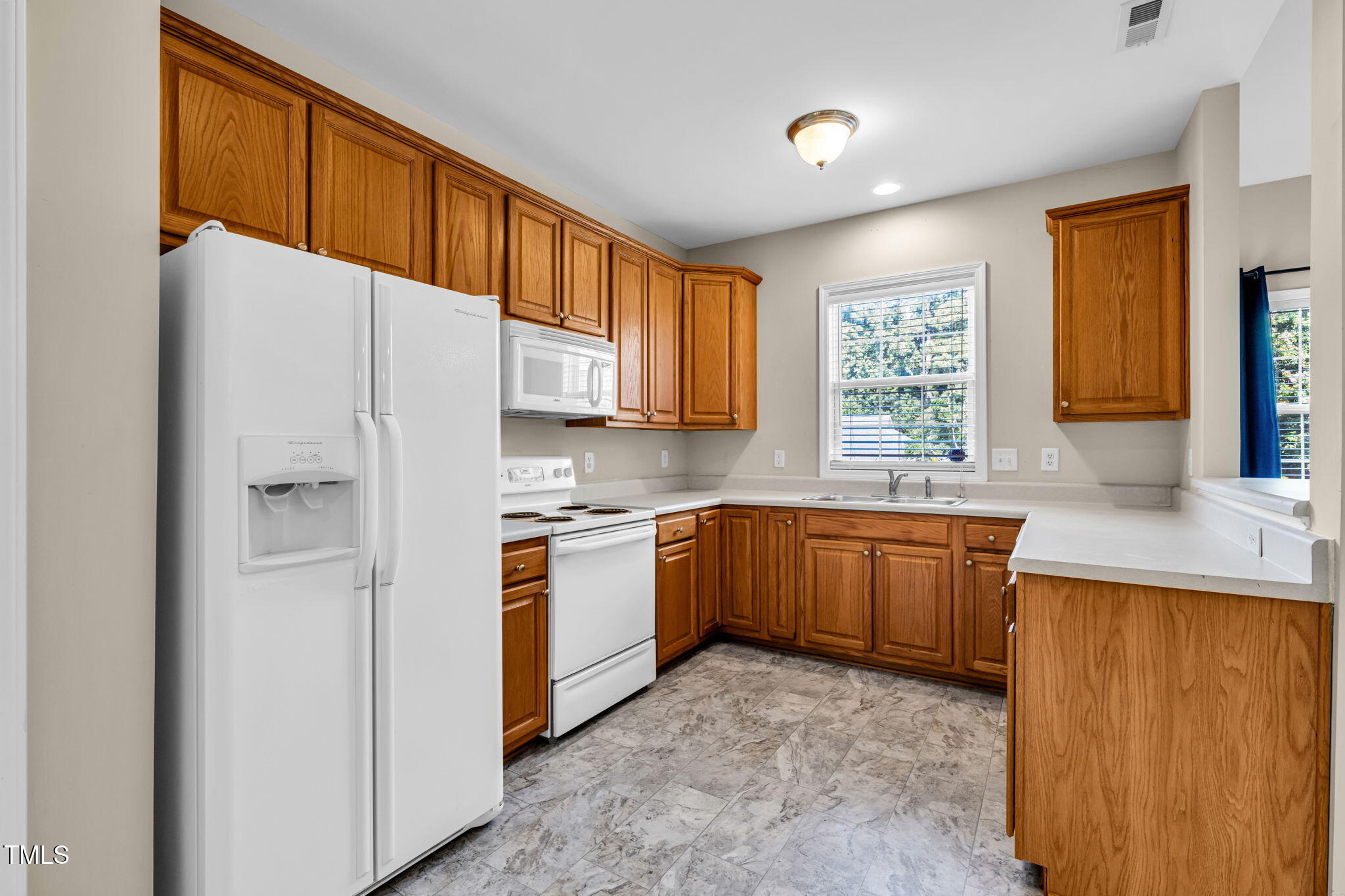 2737 Andover Glen Road Raleigh, NC 27604 - Photo 7 of 36 a kitchen with stainless steel appliances granite countertop a refrigerator a sink dishwasher a stove with wooden cabinets and floor