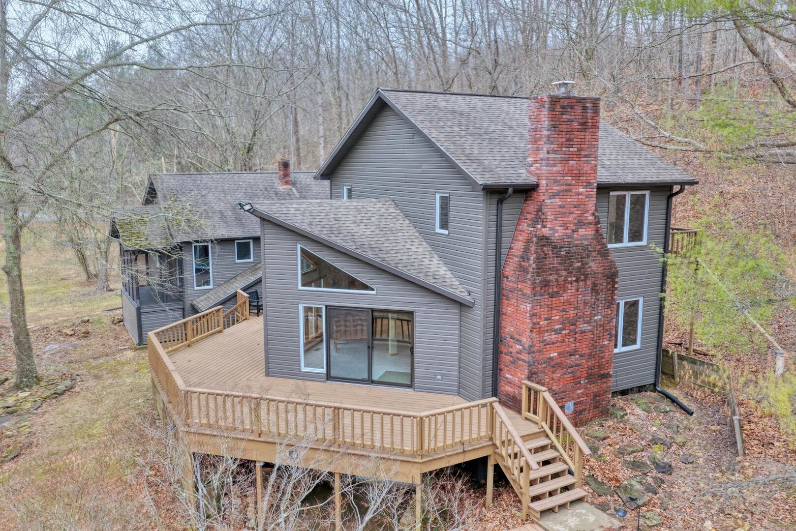 a view of a house with a deck and furniture