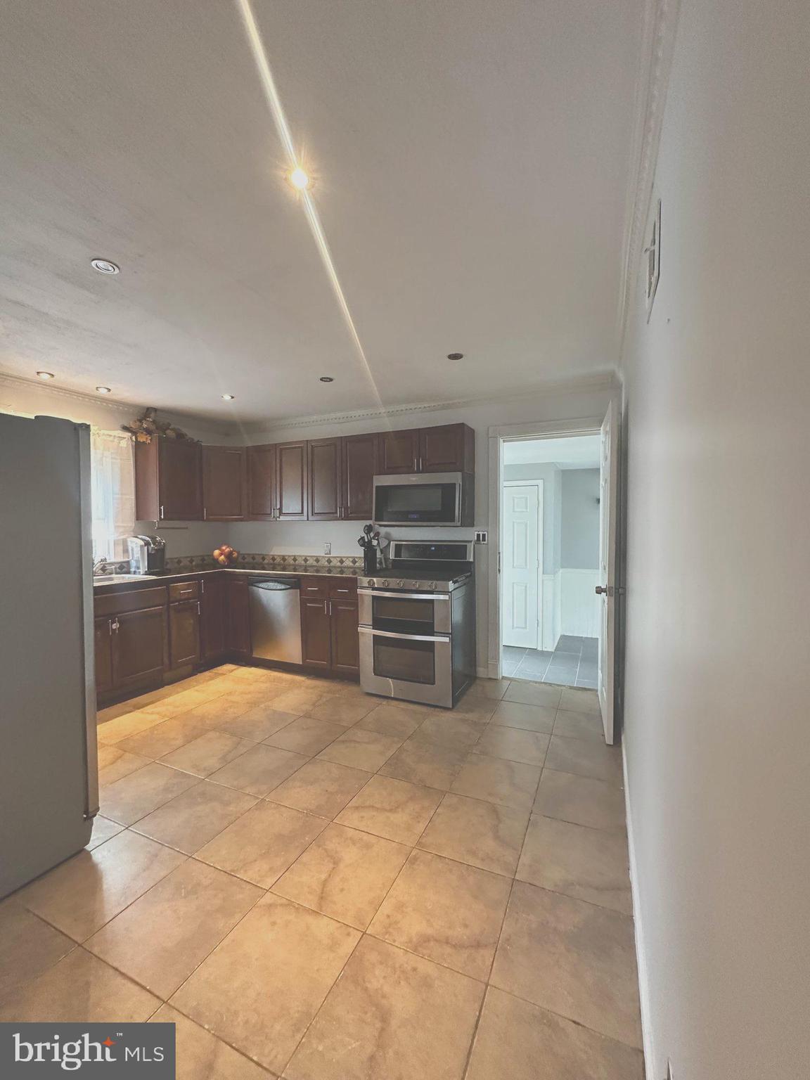 310 Pingree Avenue Ewing, NJ 08618 - Photo 10 of 28 a large white kitchen with a sink and cabinets