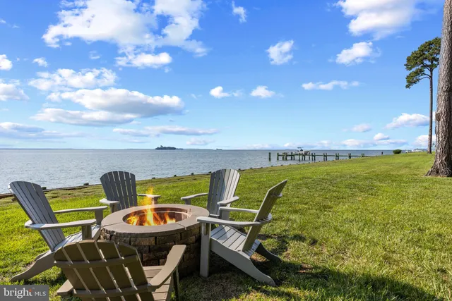 a view of a patio with a table chairs and garden