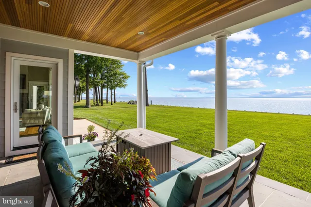 a view of swimming pool with a yard and palm trees