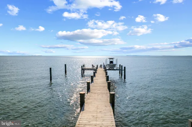 a bedroom with a large bed and a flat tv screen on dresser