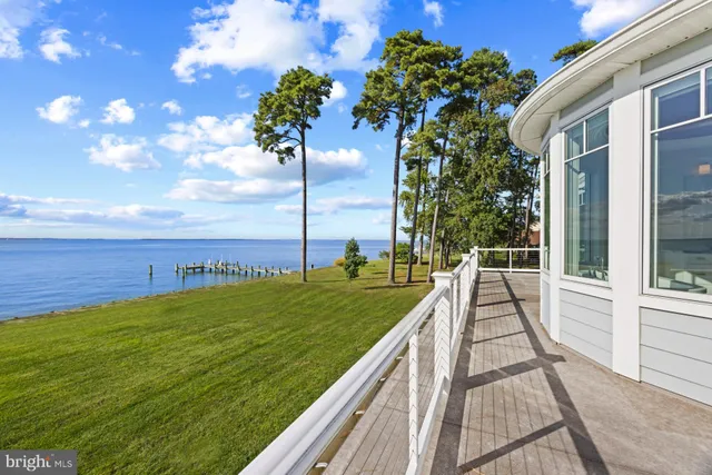 a view of a bedroom with baby bed and a chandelier