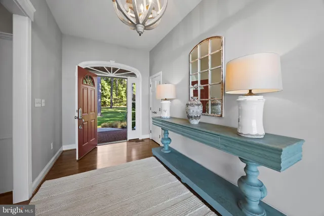 a living room with furniture floor to ceiling window and a flat screen tv
