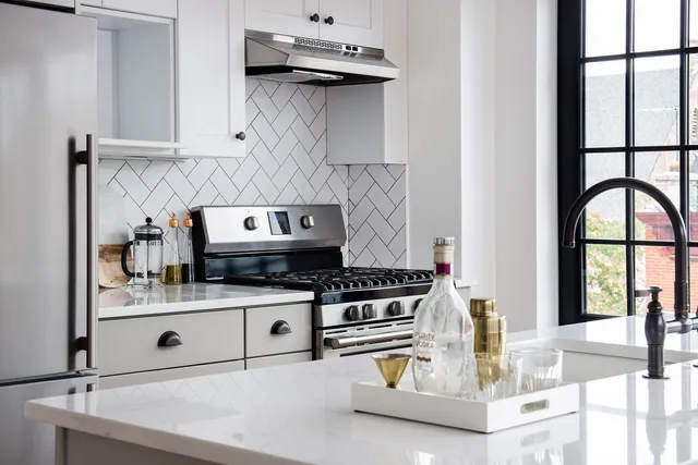 a kitchen with a stove and a cabinets