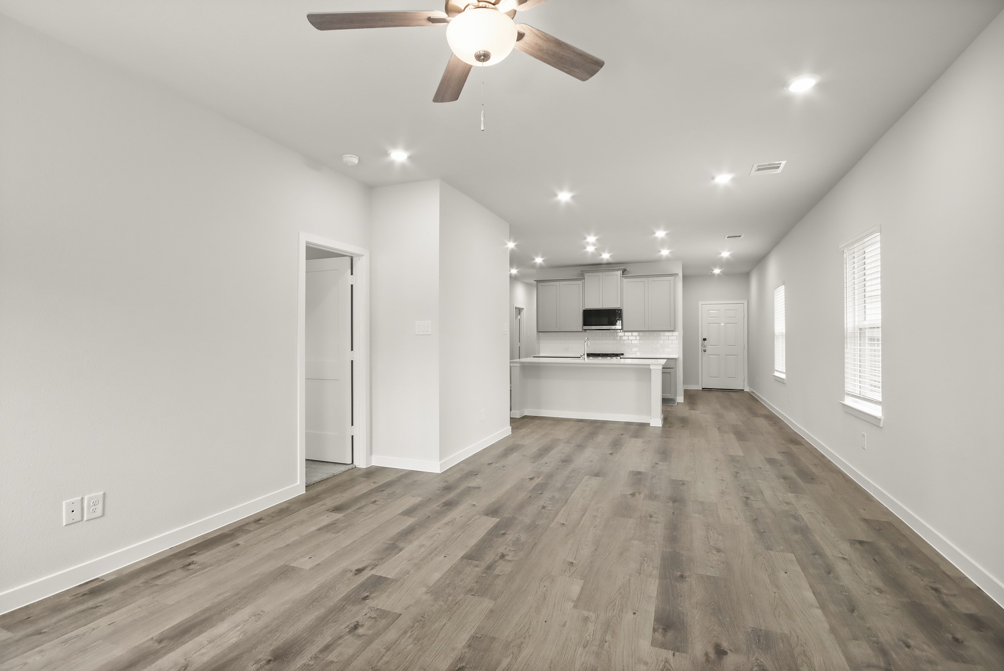 225 Spring Drive Hockley, TX 77447 - Photo 5 of 24 a view of kitchen with wooden floor and a refrigerator