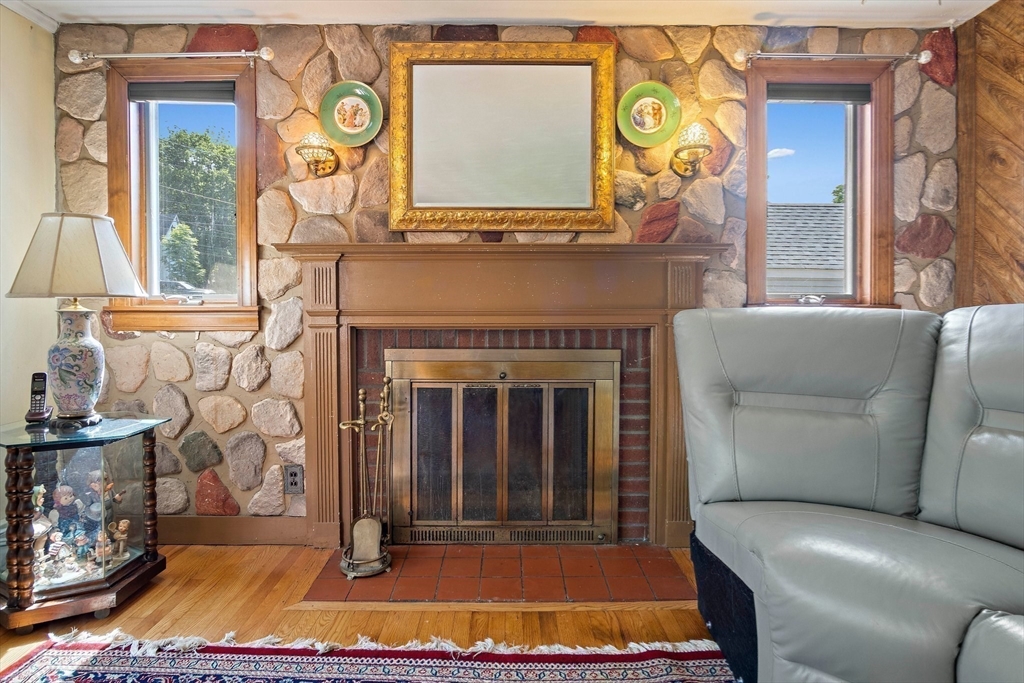 4 Merrow Lane Stoneham, MA 02180 - Photo 14 of 33 a living room with furniture and a fireplace