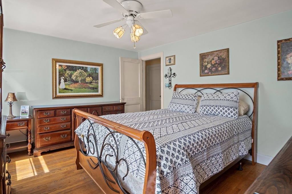 4 Merrow Lane Stoneham, MA 02180 - Photo 17 of 33 a bedroom with bed and paintings on the wall