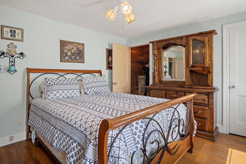 4 Merrow Lane Stoneham, MA 02180 - Photo 18 of 33 a bedroom with a bed and wooden floor