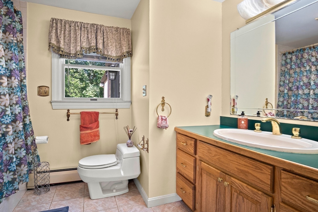 4 Merrow Lane Stoneham, MA 02180 - Photo 21 of 33 a bathroom with a granite countertop toilet sink and mirror