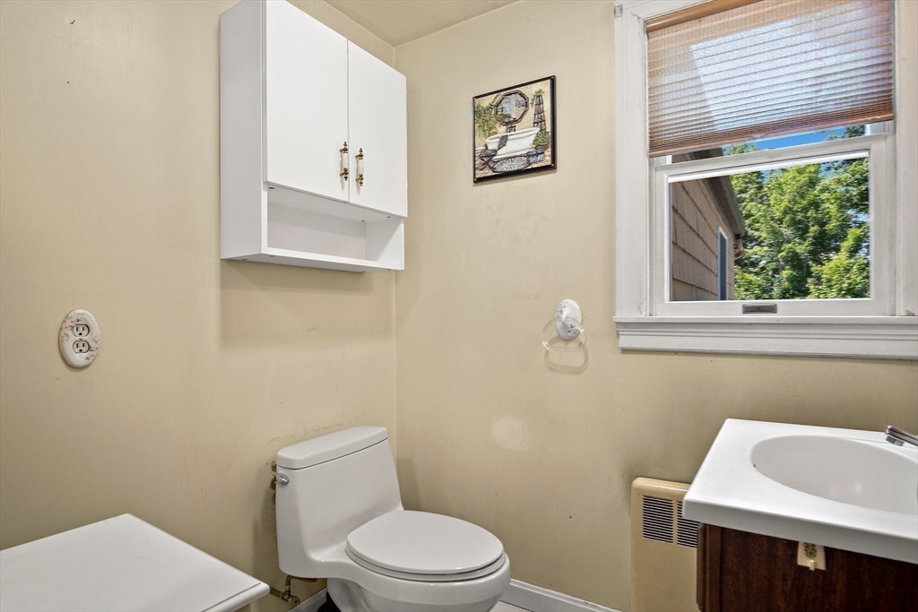 4 Merrow Lane Stoneham, MA 02180 - Photo 22 of 33 a white toilet sitting next to a bathroom sink