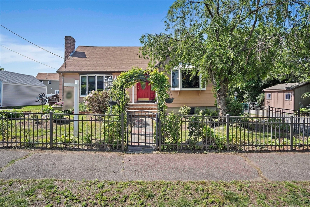 4 Merrow Lane Stoneham, MA 02180 - Photo 30 of 33 a front view of a house with a garden