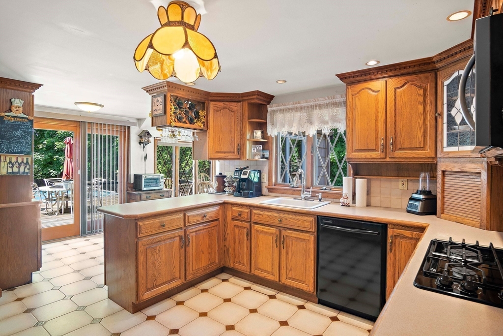 4 Merrow Lane Stoneham, MA 02180 - Photo 3 of 33 a kitchen with stainless steel appliances granite countertop a sink and cabinets