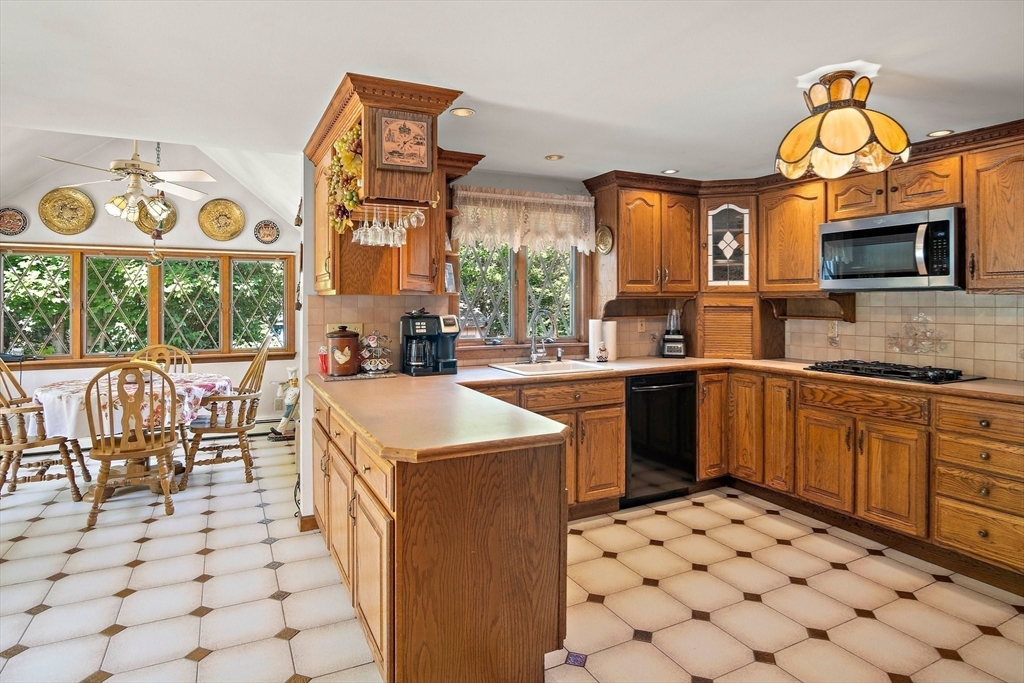 4 Merrow Lane Stoneham, MA 02180 - Photo 5 of 33 a kitchen with a sink and a stove top oven