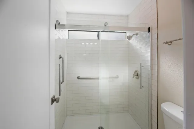 a bathroom with a shower and toilet