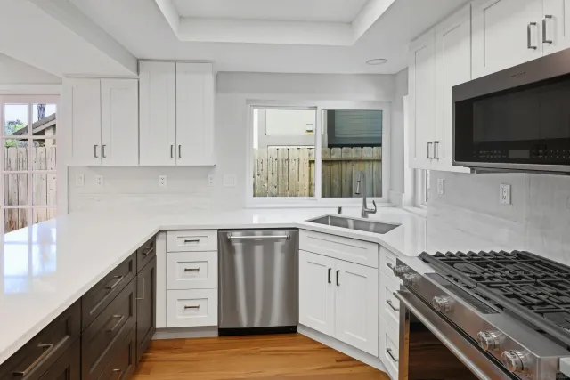 a kitchen with a sink stove and microwave