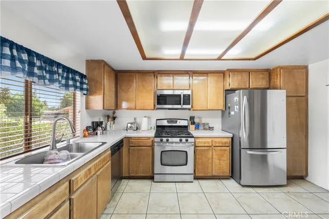 a kitchen with a stove sink and refrigerator