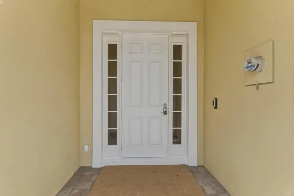 an empty room with wooden cabinet and a ceiling fan