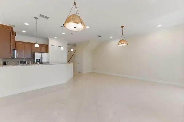 a kitchen with granite countertop kitchen island white cabinets and a sink