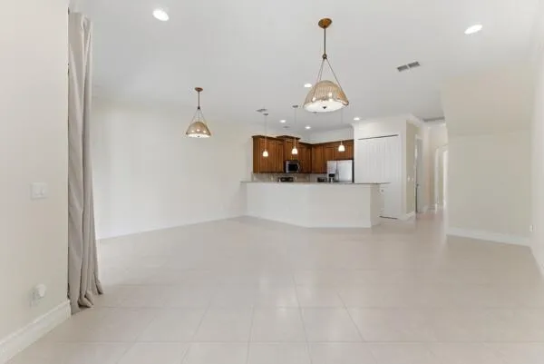 a kitchen with kitchen island a sink stainless steel appliances and cabinets