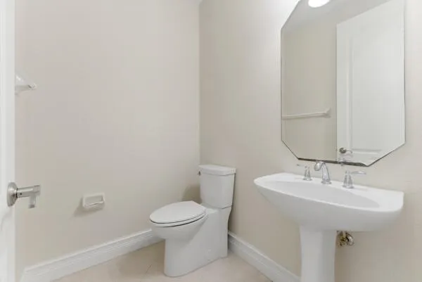 a bathroom with a tub a sink and a mirror