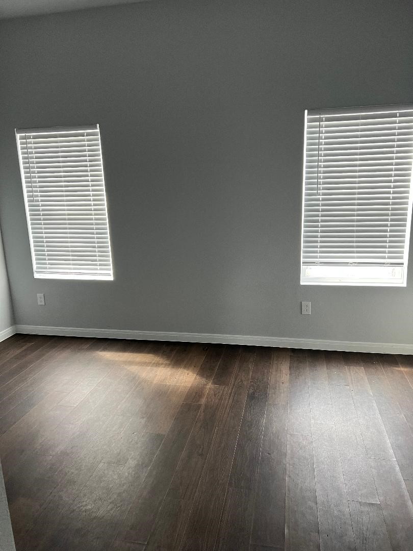 18819 Luminescent Ln Spring Spring, TX 77379 - Photo 12 of 15 an empty room with wooden floor and windows