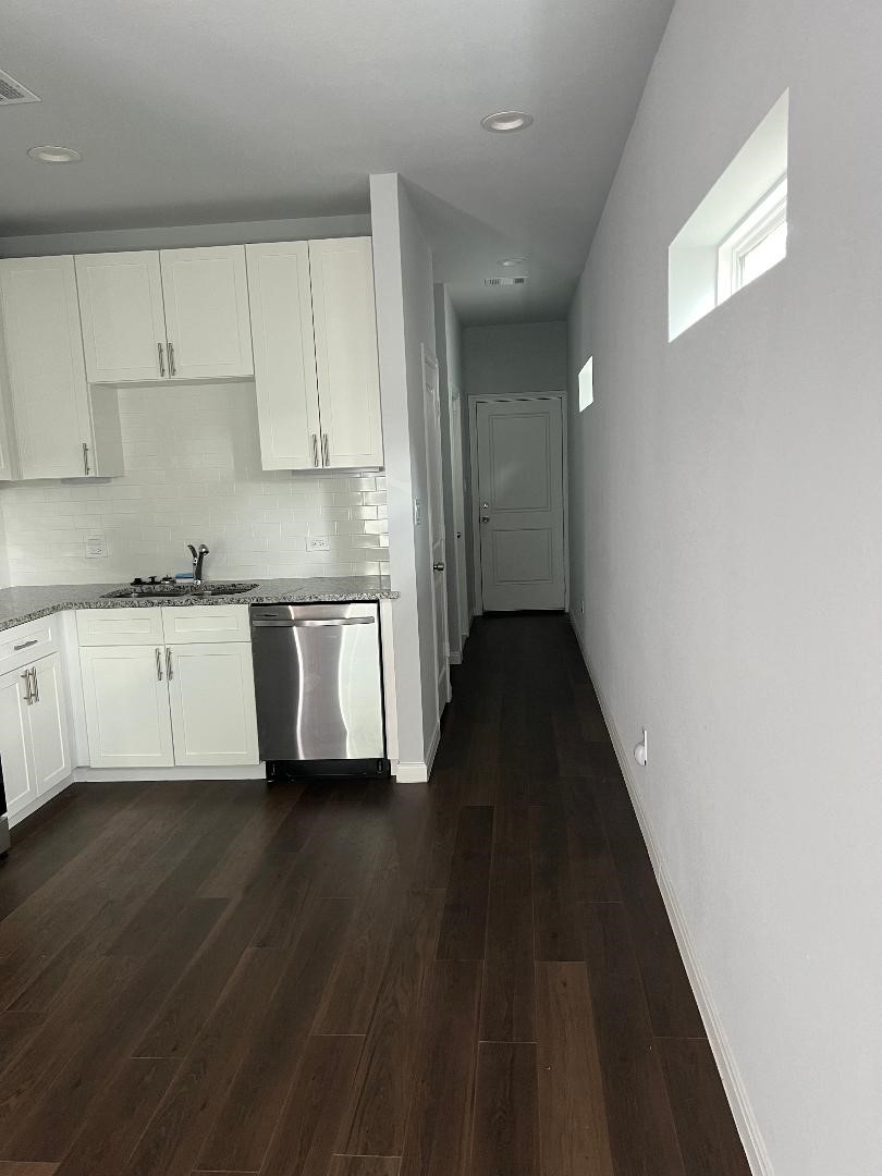 18819 Luminescent Ln Spring Spring, TX 77379 - Photo 13 of 15 a kitchen with stainless steel appliances a sink cabinets and wooden floor