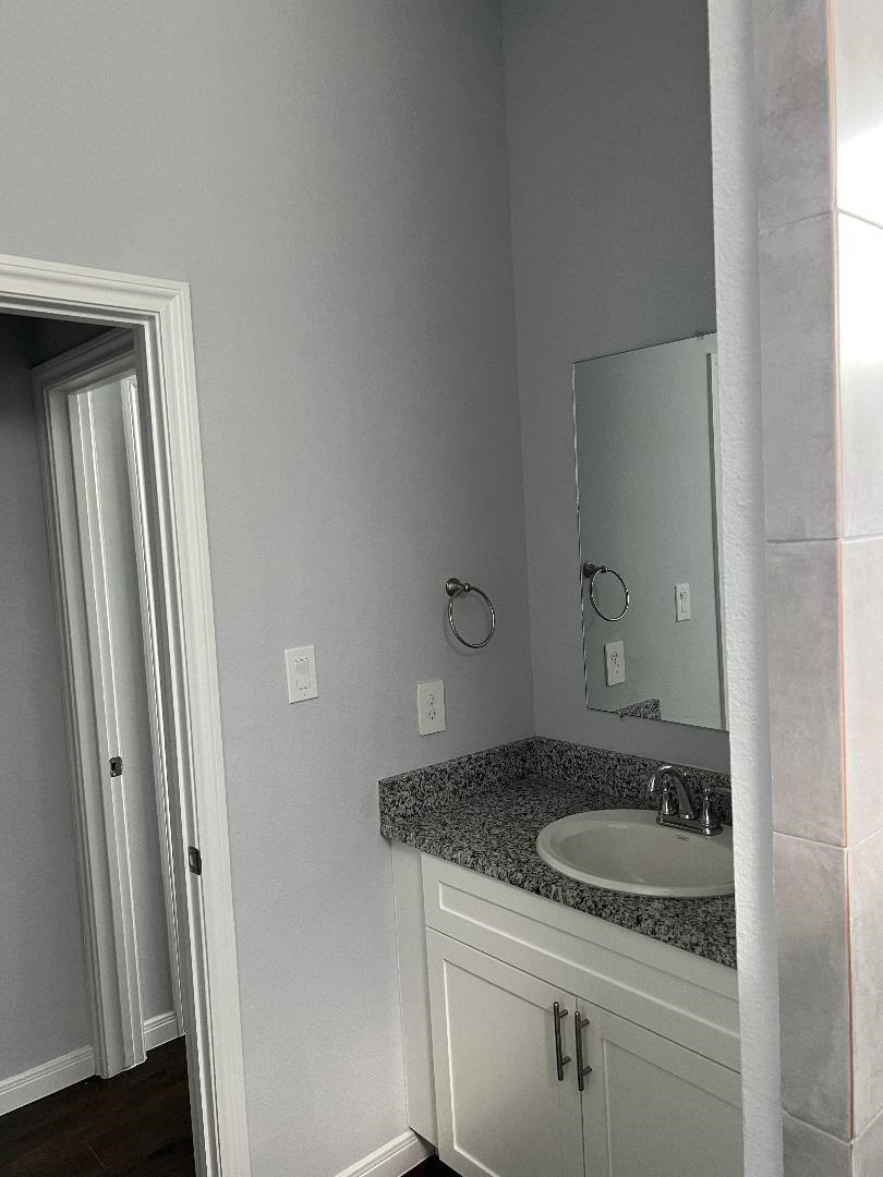18819 Luminescent Ln Spring Spring, TX 77379 - Photo 7 of 15 a bathroom with a granite countertop sink and a mirror