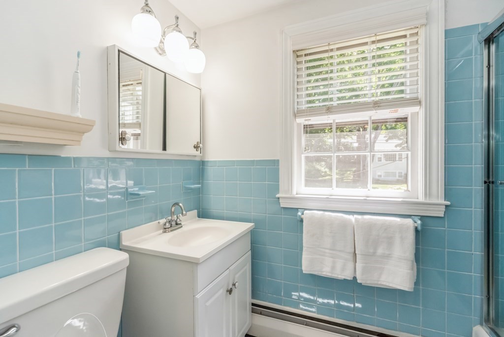 110 Parker Road Needham, MA 02494 - Photo 17 of 33 a bathroom with a sink a toilet and a mirror