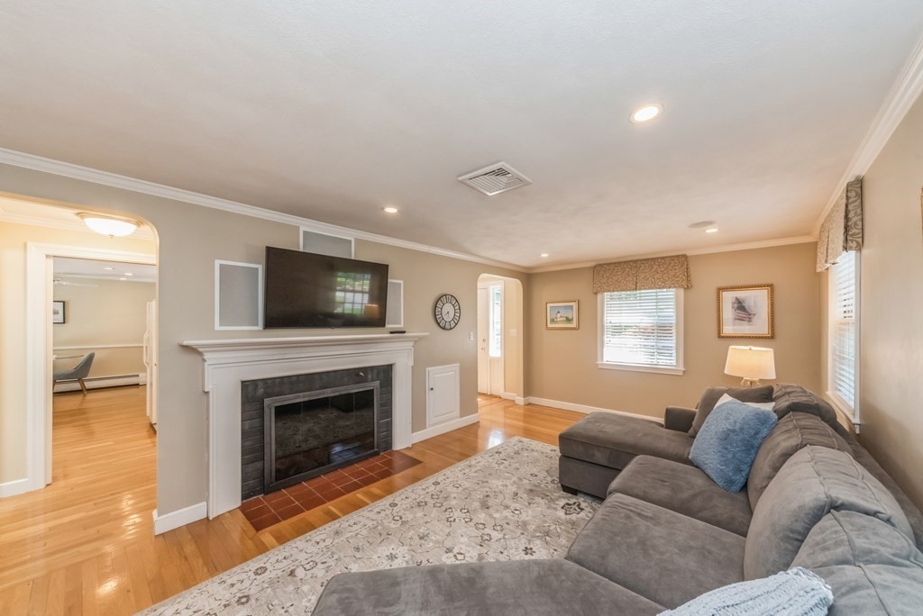 110 Parker Road Needham, MA 02494 - Photo 4 of 33 a living room with furniture a flat screen tv and a fireplace