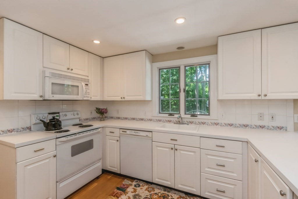 110 Parker Road Needham, MA 02494 - Photo 8 of 33 a kitchen with cabinets appliances a sink and a window