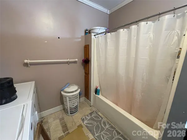 a bathroom with a toilet and a shower curtain