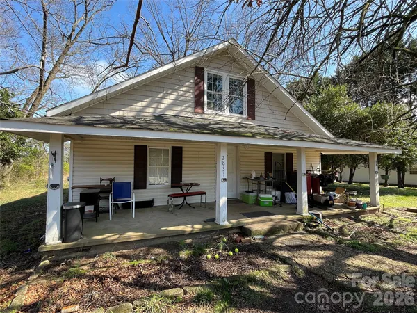 a front view of a house with outdoor seating