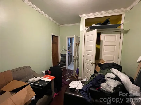 a bedroom with a bed and a couch