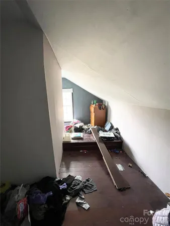 a bedroom with bed and a window