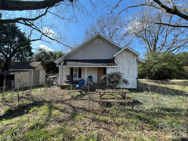 a view of a house with a yard patio and sitting area