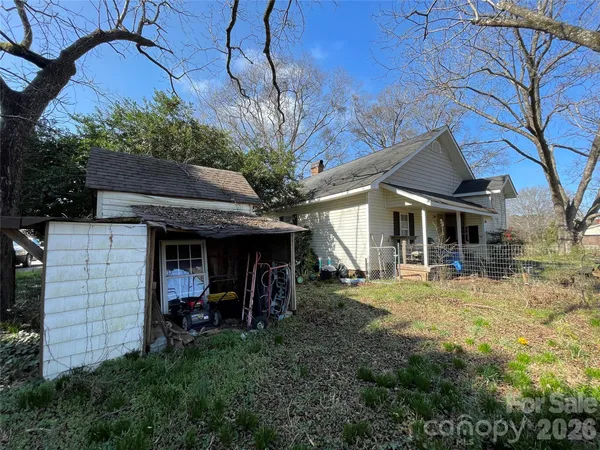 a view of a house with a yard and furniture
