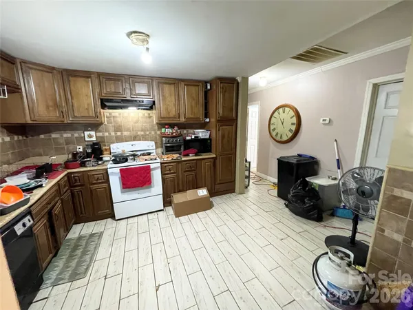 a kitchen with a stove a refrigerator and a sink