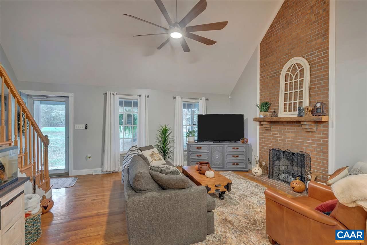 792 Fanny White Road Buckingham, VA 23921 - Photo 3 of 50 a living room with furniture a fireplace and a flat screen tv