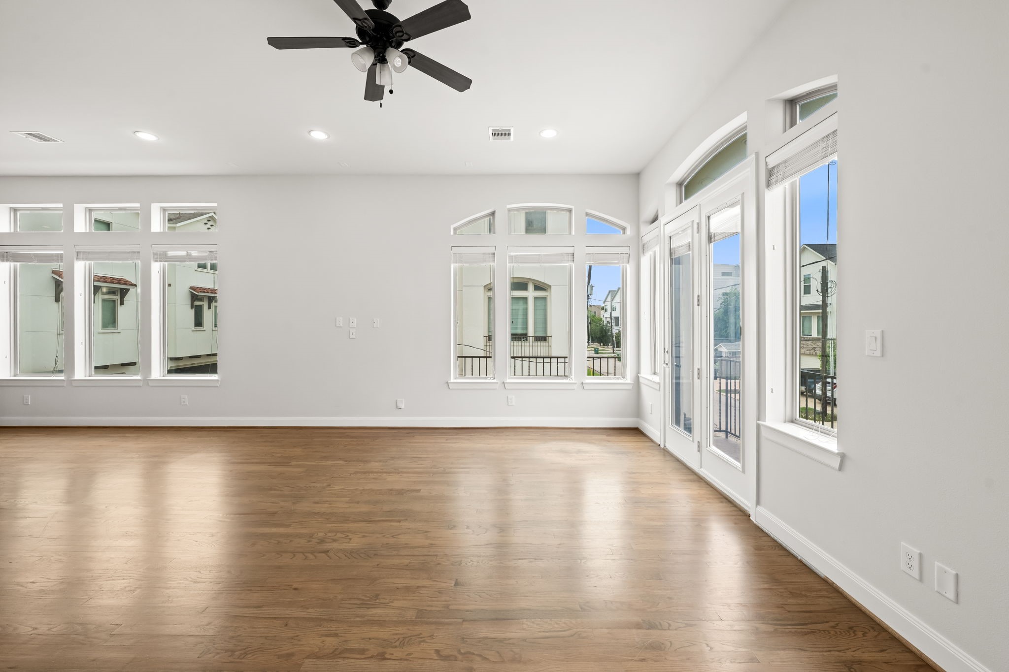 4115 Schuler Street Houston, TX 77007 - Photo 11 of 32 Light filled living space with hardwood floors, tall windows, and access to a private balcony.
