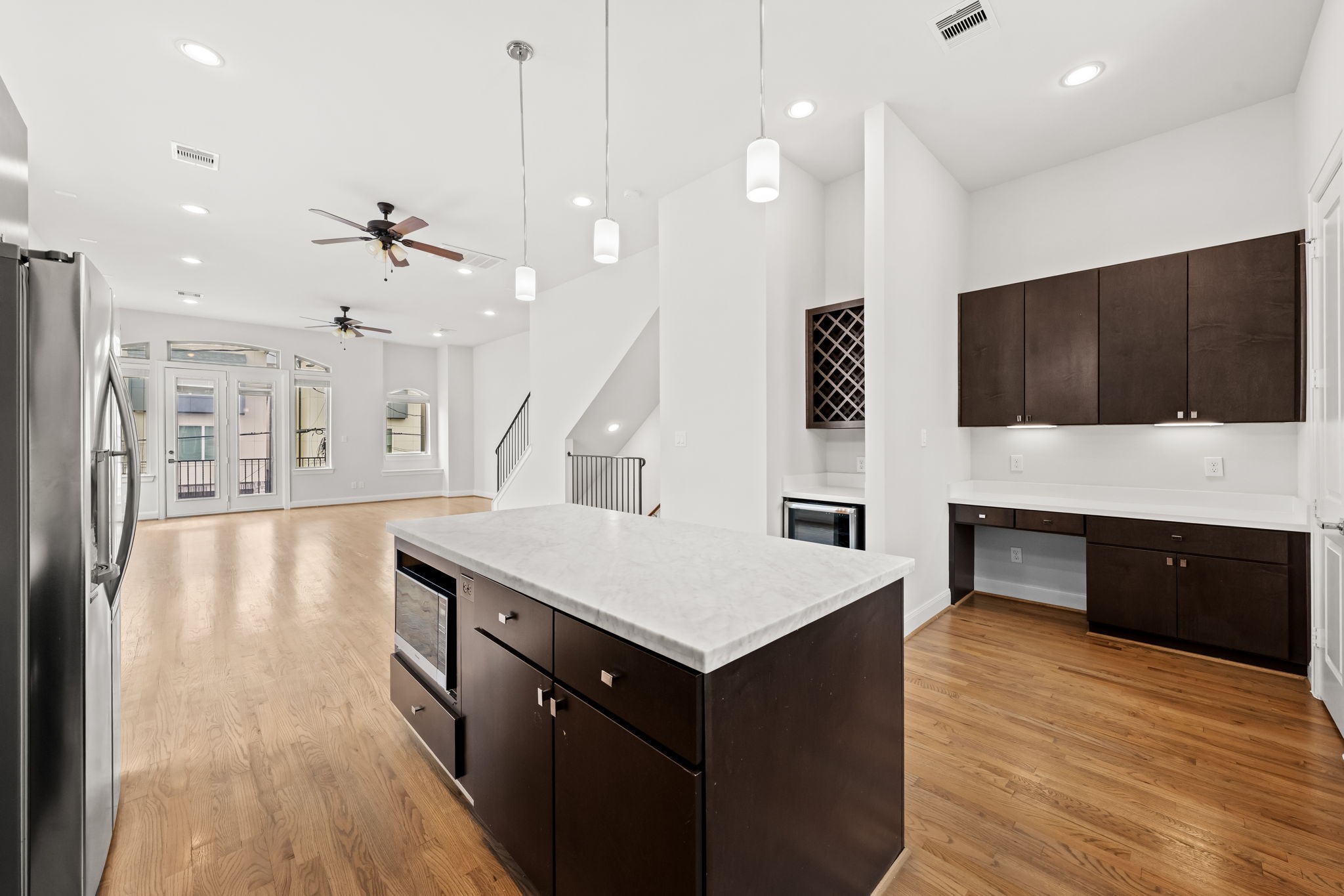 4115 Schuler Street Houston, TX 77007 - Photo 18 of 32 Light filled kitchen with the generous island, eye catching backsplash, built in wine rack, and a convenient workspace with ample storage.