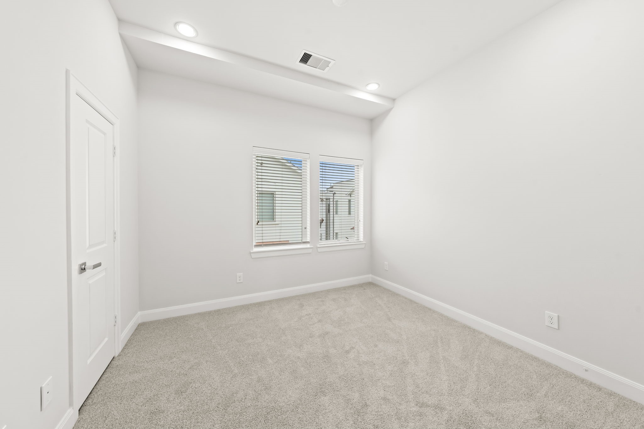 4115 Schuler Street Houston, TX 77007 - Photo 19 of 32 Secondary bedroom with brand new carpeting, natural light and a clean and neutral palette.