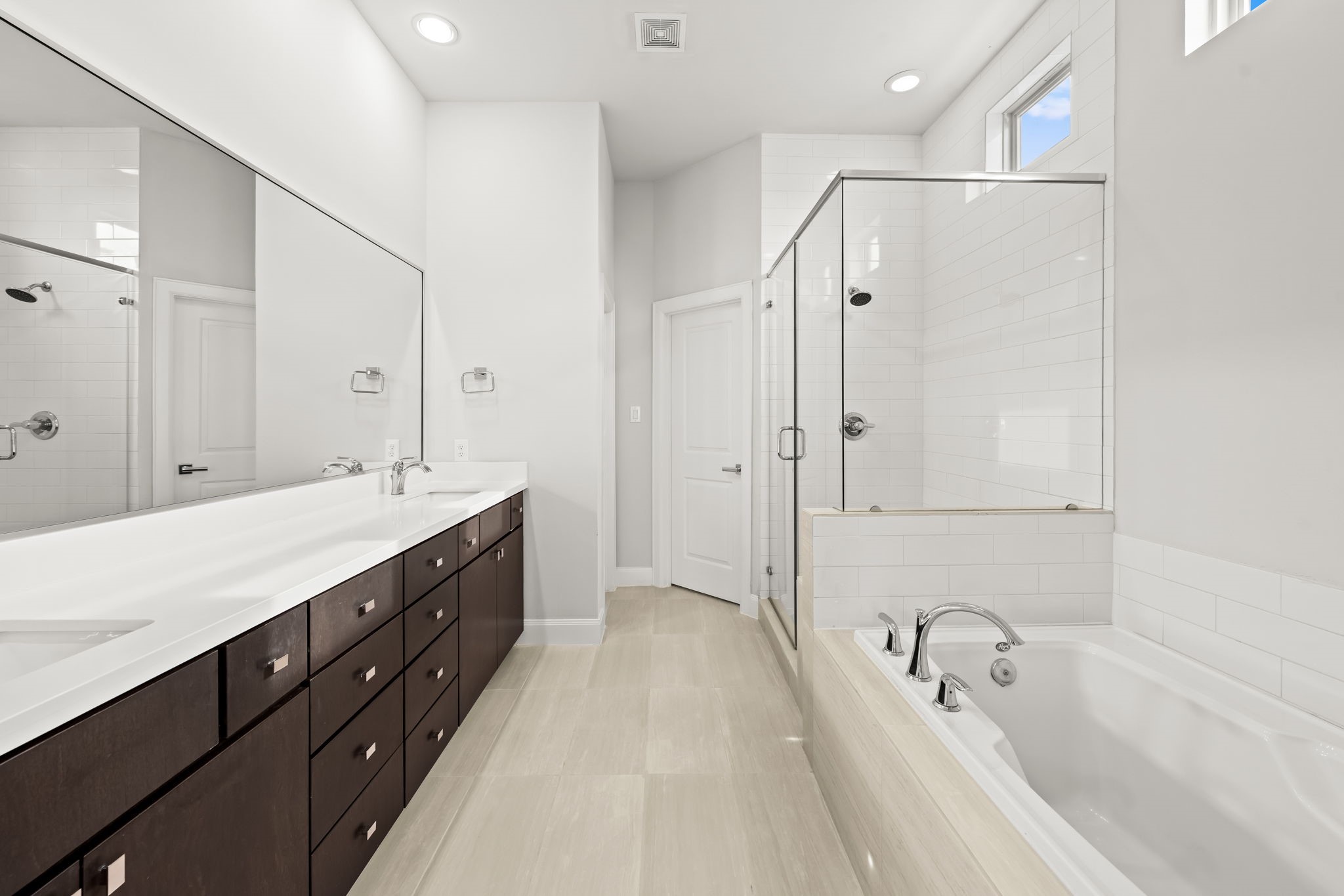 4115 Schuler Street Houston, TX 77007 - Photo 23 of 32 Spa like primary bath featuring dual vanities, a soaking tub, and a separate glass enclosed shower.